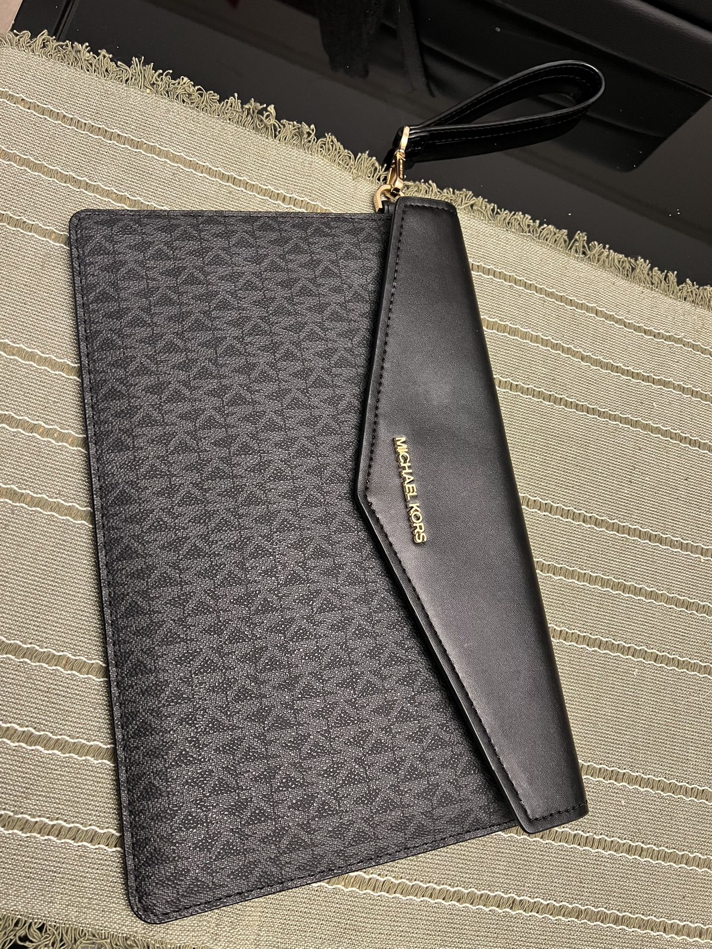 MICHAEL KORS black leather clutch/purse with wristlet and signature logo pattern *NEVER USED*