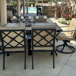 7 piece outdoor patio set. 2 swivel armchairs. Tile tabletop. 