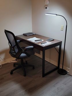 Beautiful Desk With Chair. Brown Wood With Black Steel Legs. There Is a Drawer  In The Front Of The Desk. 