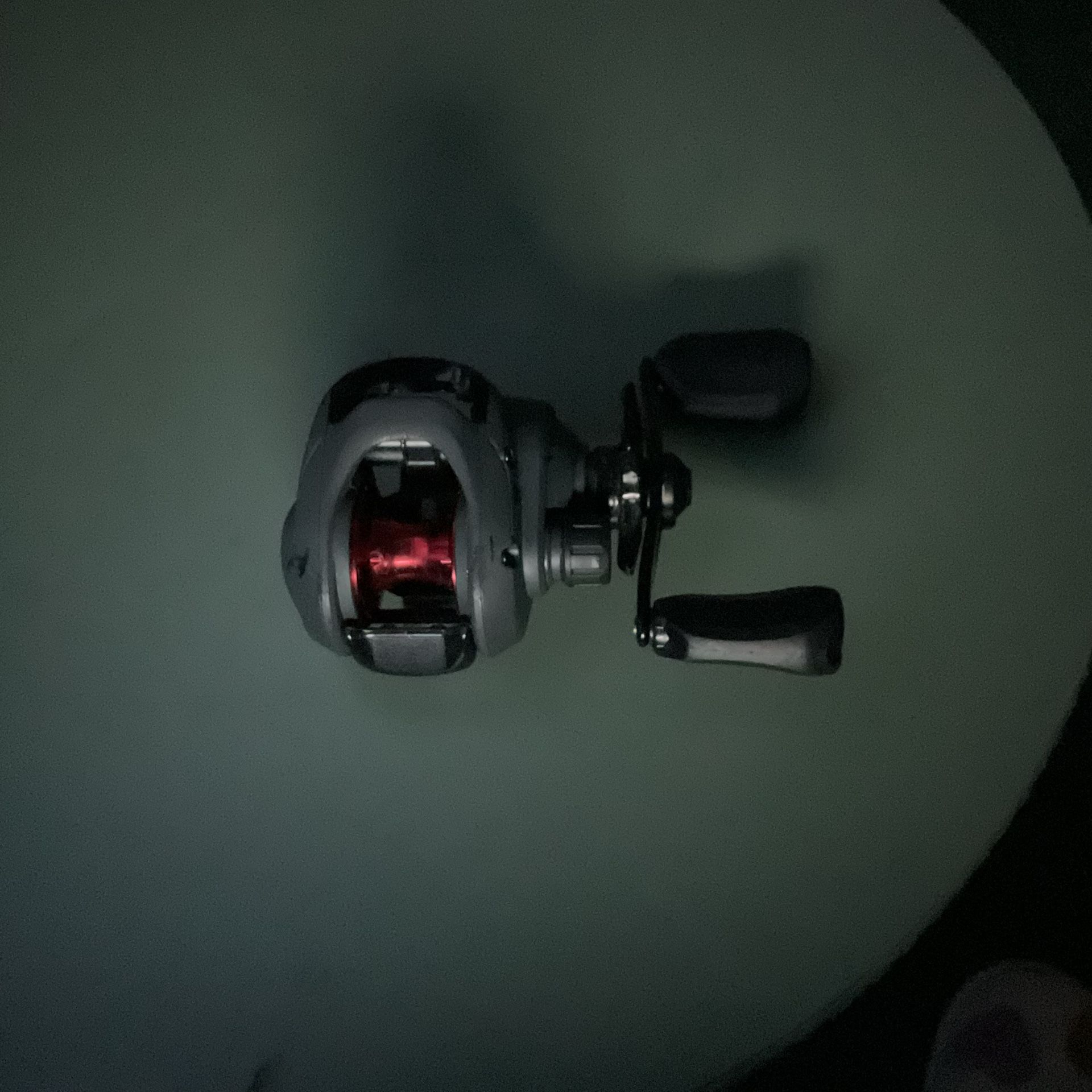 Red and black bait caster fishing reel