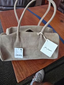 Free People This totally tubular shoulder bag features signature FP Collection vintage-inspired touches in an all-over suede fabrication with an inter