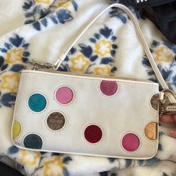 white leather Coach wristlet | multicolor polka dot
