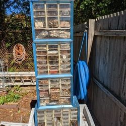 Four vintage metal storage bins with plastic drawers.