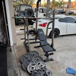 Bench press/squat rack with pulley systems and 7ft bar plus 255lbs of Olympic weights