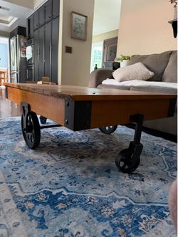 Nice maple or light cherry wood industrial style wheeled coffee table.