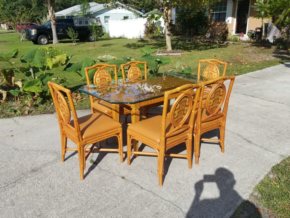 Rattan glass top table with 6 Chairs 38 by 64