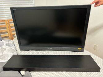 Sony 46 inch BRAVIA LCD television with floating shelf and tv mount .