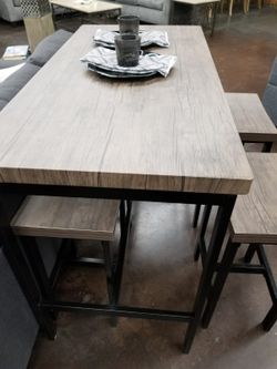 Grey counter height table with 4 stools
