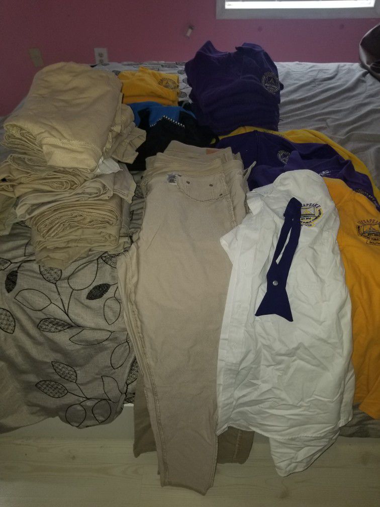 CMIT south Uniforms & 2 duffle Bags. Eropostel and Old Navy pants size 12, 3 M Jackets,14 purple and Yellow Shirts w/ logo, white Shirt w/ tie 