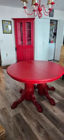 Red dinjng table and corner curio cabinet