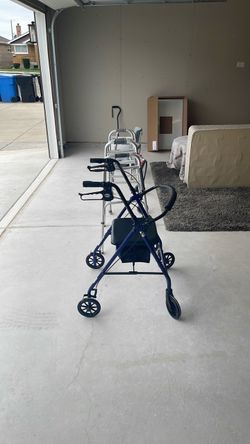 Blue 4-Wheel Drive brand rotating Walker + 2 tradional walkers, a hemi walker, cane, shower seat, a couple bed pans, & an elevated seat.