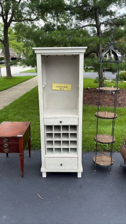 Lighted wine rack with cubbies and two drawers.