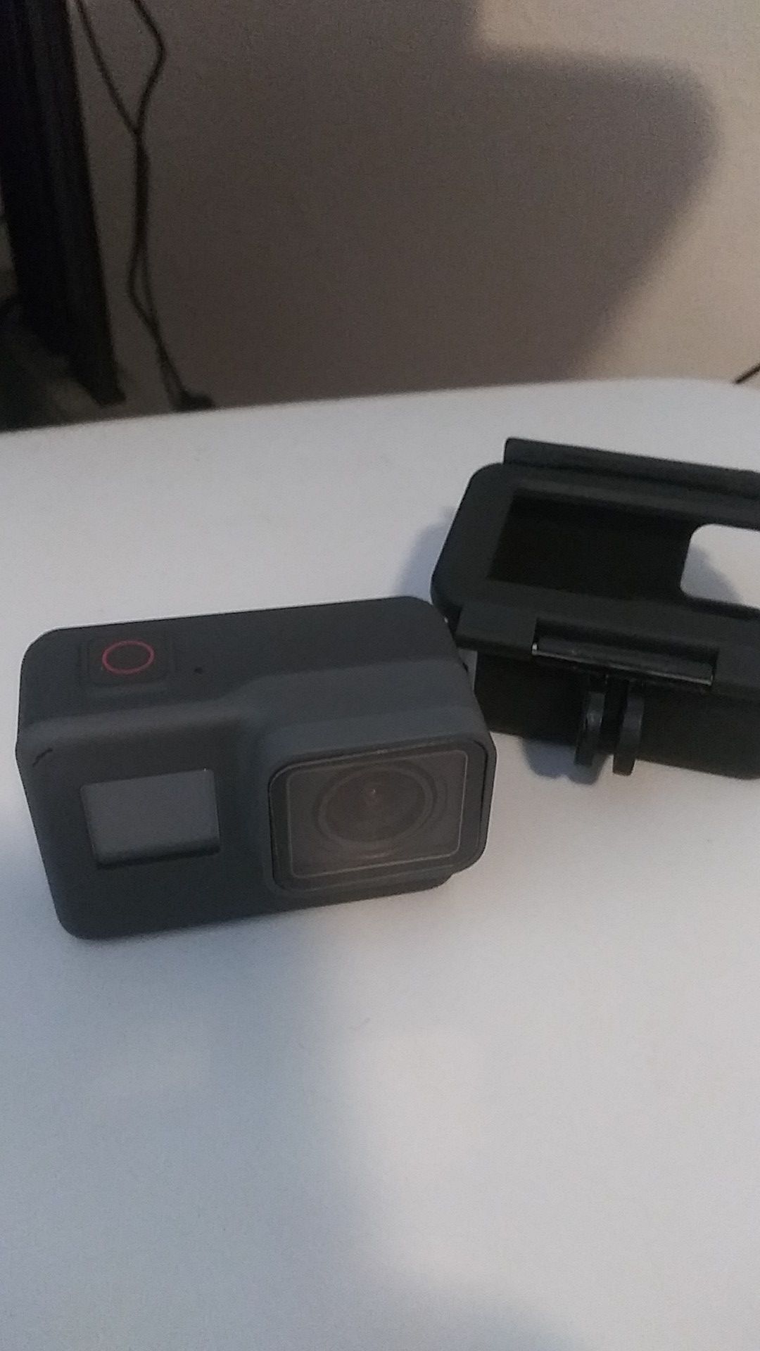 Gopro Hero 6 Black with case. Screen is minty because it is wearing a screen saver.