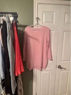 Soft light pink long sleeve tunic. Simple crew neckline. Relaxed, versatile silhouette. Great layered or worn alone.Zipper detail on each side, adjust