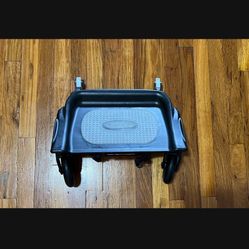 This is a Baby Jogger Glider Board, an attachment that allows an older child to stand and ride on the back 