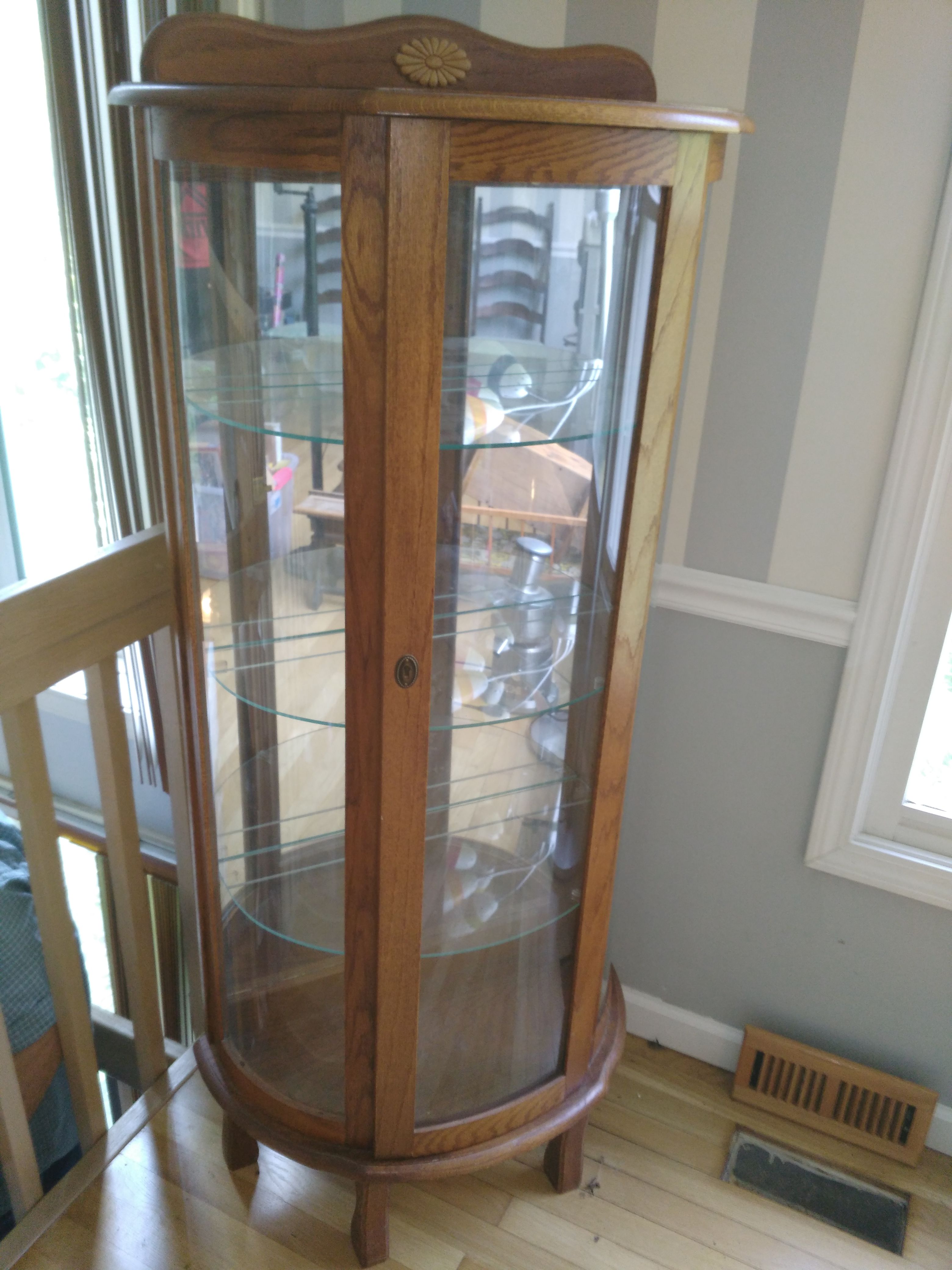Beautiful round glass front curio with mirror back and glass shelves for sale