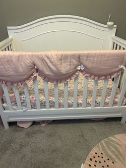 Beautiful white crib with bedding and mattress