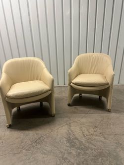 Pair of Swivel ivory chairs