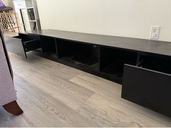 Low profile black TV stand with ample storage. 15”Wx94.5”Lx12”H