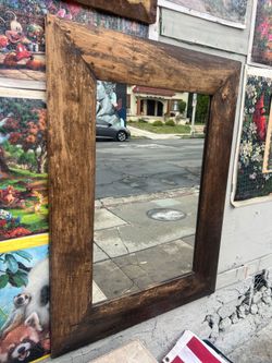 brown wood frame rectangular wall mirror