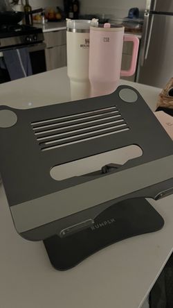 RUMPLN adjustable ergonomic laptop stand with a ventilated panel and non-slip rubber pads