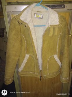 l.i.esize small brown wool like material and swa de Like on the outside