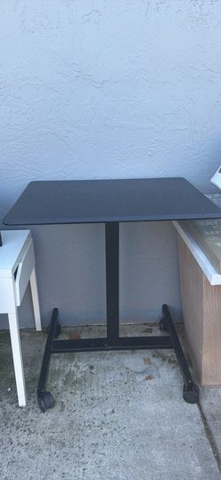Black adjustable rolling table