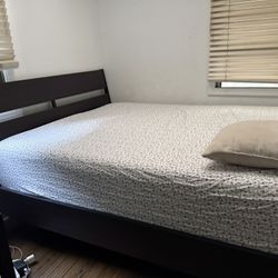 Dark wood queen-size bed