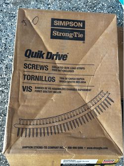 Unused collated subfloor screws with a yellow zinc coating