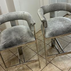 2 Interlude Darcy Counter Stools Featuring Natural Hide Seats And Stainless Steel Frames In Polished Finish 