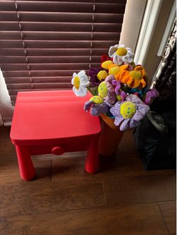 IKEA red kid table with pot of flowers