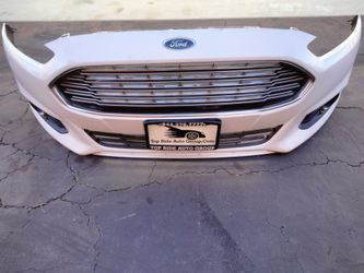 2013-2016 Ford Fusion complete front bumper with all the accessories OEM.