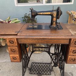 Antique Singer 9W7 sewing machine head with ornate gold decals.