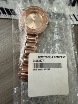 New York & Company (NYC) rose gold-toned bracelet wristwatch featuring a crystal-accented bezel and a shimmering inner dial