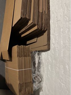 Moving boxes and 2 bundles of packing paper