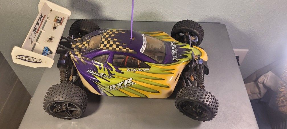 The RC car in the image is an HSP XSTR 1/10 scale off-road buggy.