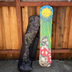 Evol Snowboard With Dakine Bag