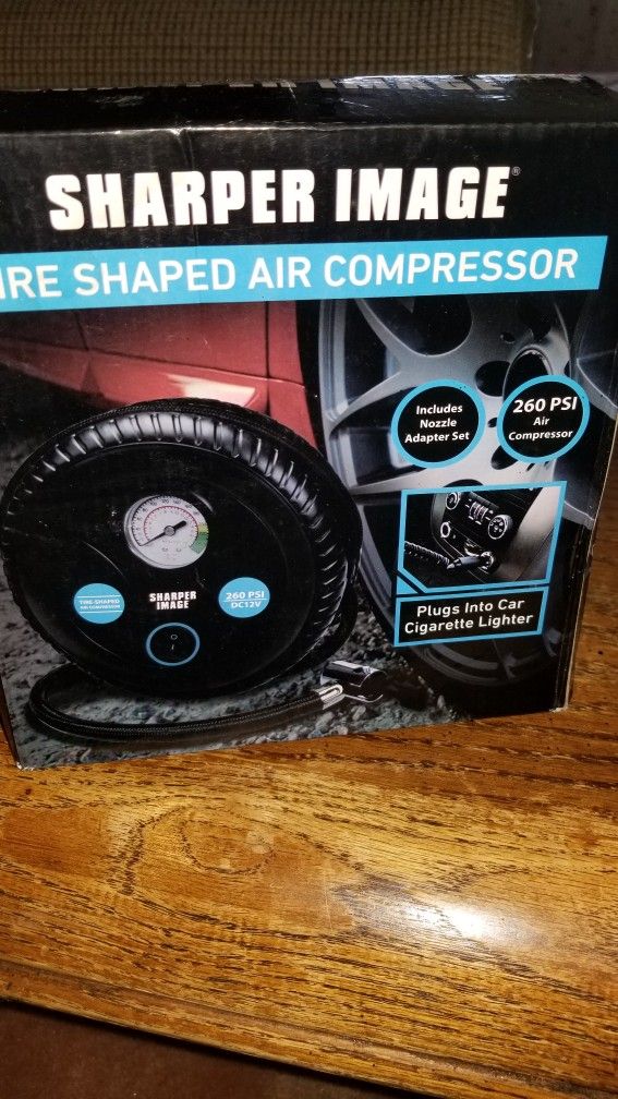 NEW IN BOX SHARPER IMAGE TIRE SHAPED AIR COMPRESSOR.  PICK UP MIDDLEBORO ONLY FINAL SALE 