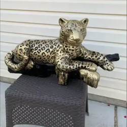 Golden leopard on the log statue