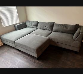 Grey sectional couch with ottoman
