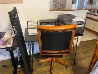 Black metal desk with leather chair