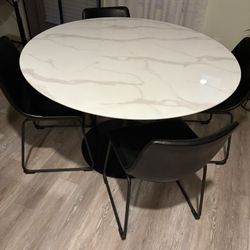 White marble table and black chairs 