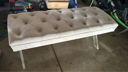 Grey tufted bench with clear legs