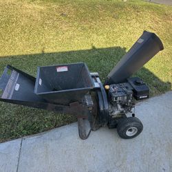 MTD Yard Machines chipper shredder, likely featuring a 10HP engine based on the text visible on the machine. 