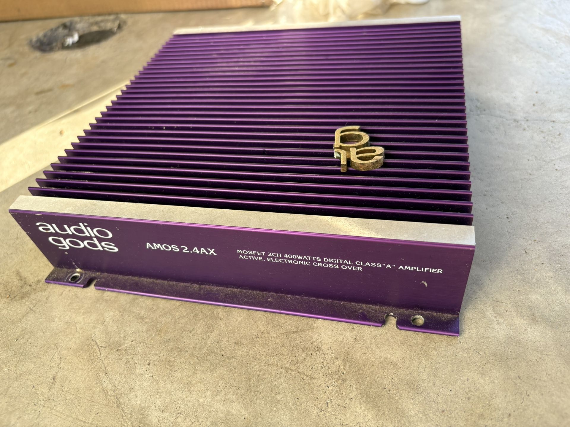 Audio Gods Amos 2.4ax 400W amplifier for car has red LED blinking.