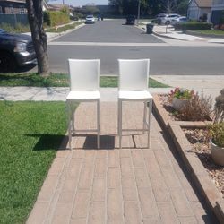Two White Chairs with Silver Leg Rests