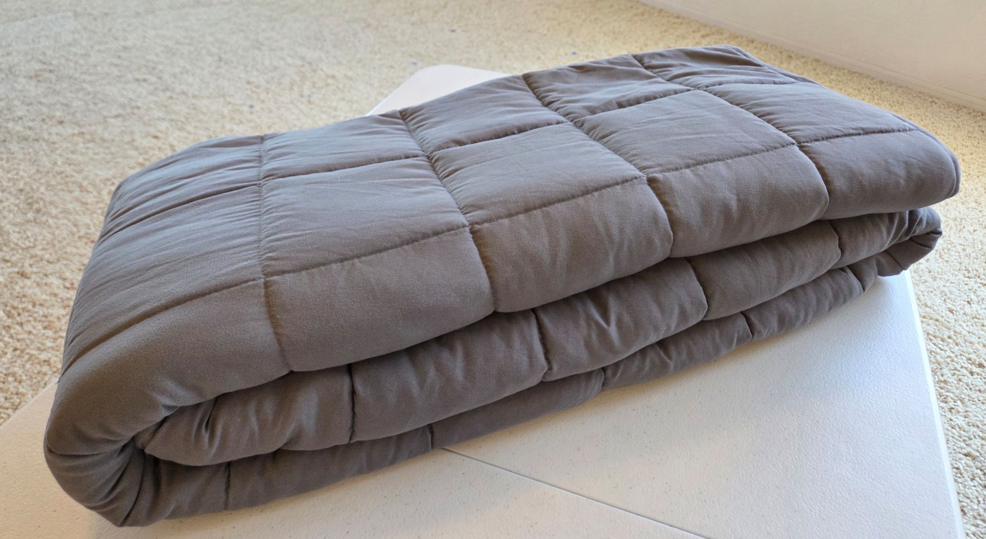 * Gray weighted sleeping bed blanket.