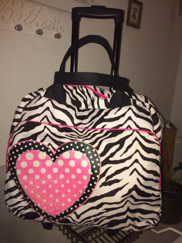 Justice black and white zebra print rolling suitcase/overnight bag. Used very little still in very good shape.