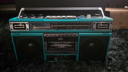 QFX J-220BT Retro Bluetooth Boombox in a vibrant turquoise color.