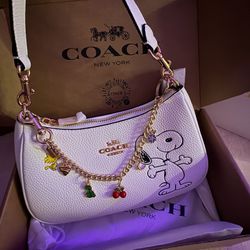 white pebbled leather shoulder bag with snoopy